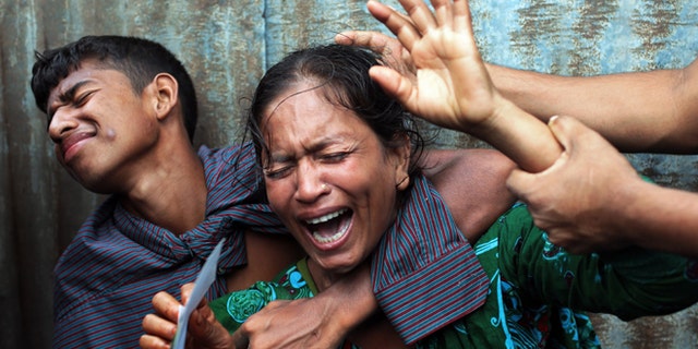 Aug. 4, 2014: Bangladeshi woman Munni, whose daughters are missing, cries as rescuers search the River Padma after a passenger ferry capsized in Munshiganj district, Bangladesh. (AP)