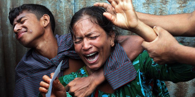 Aug. 4, 2014: Bangladeshi woman Munni, whose daughters are missing, cries as rescuers search the River Padma after a passenger ferry capsized in Munshiganj district, Bangladesh. (AP)