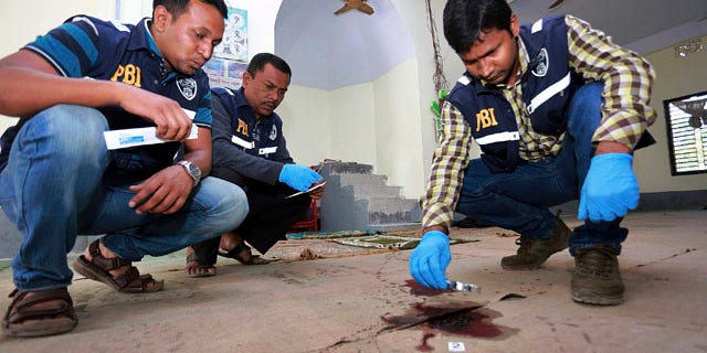 Nov. 27, 2015: Investigators inspect a mosque that was attacked by unidentified gunmen during evening prayers on Thursday in northern Bangladesh's Bogra district. (AP Photo)