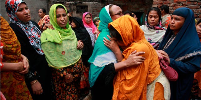 June 4: Relatives mourn the death of a victim of a fire in Dhaka, Bangladesh. The devastating fire raced through several apartment complexes in the Bangladeshi capital Thursday, killing and injuring scores of people. (AP)