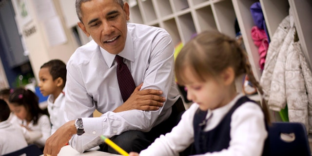 President Barack Obama sits with Emily Hare as she completes her spelling lessons during his visit to a preschool classroom at Powell Elementary School in the Petworth neighborhood of Washington, Tuesday, March 4, 2014. Obama visited the school to talk about his 2015 budget proposal, which was released today. Powell elementary has seen rapid growth in recent years and serves a predominantly Hispanic student body. Washington DC Mayor Vincent Gray, who greeted Obama at the school, recently directed $20 million to Powell for a planned modernization and addition. (AP Photo/Pablo Martinez Monsivais)