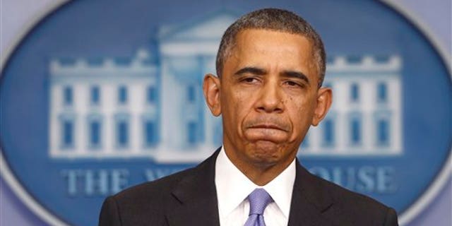 FILE - In this Nov. 14, 2013 file photo, President Barack Obama pauses while speaking about his signature health care law, in the Brady Press Briefing Room of the White House in Washington. (AP Photo/Charles Dharapak, File)