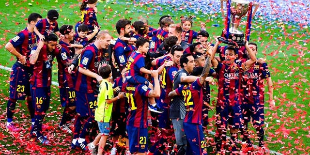 FC Barcelona players celebrate with La Liga trophy at Camp Nou on May 23, 2015 in Barcelona, Spain.