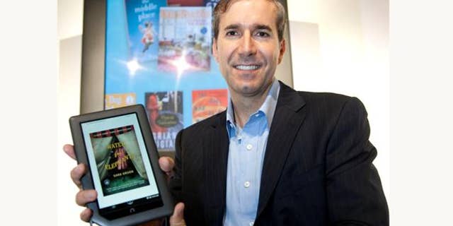 William Lynch, Chief Executive Officer of Barnes & Noble, holds the new NOOKcolor, the first full-color touch reader's tablet, prior to its introduction in New York on Tuesday, October 26, 2010. Designed to read many types of content, NOOKcolor has a 7-inch display that showcases books, a large selection of magazines and newspapers and children's picture books in rich color.