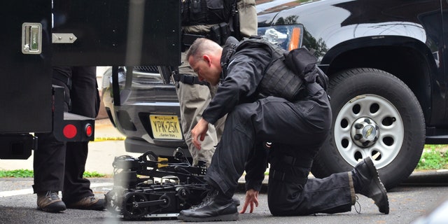 May 10, 2013: A state police swat team member readies a robot to enter a home where a man had barricaded himself in Trenton, N.J.