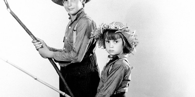 FILE -This Jan. 26, 1931 file photo shows actor Jackie Coogan, left, with his young brother Robert Coogan. Jackie Coogan rose to fame after appearing in Charlie Chaplins 1921 film The Kid and earned approximately $4 million before reaching adulthood. He sought his earnings from his mother and step-father in the 1930s, but was refused and sued, only to be rebuffed for most of the money because California law didnt allow minors to have any rights to their earnings. (AP Photo, File)