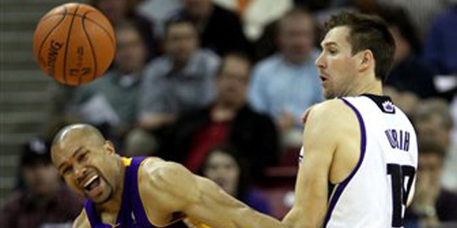 Los Angeles Lakers guard Derek Fisher, left, and Sacramento Kings guard Beno Udrih, of Slovenia collide during the a game in Sacramento.