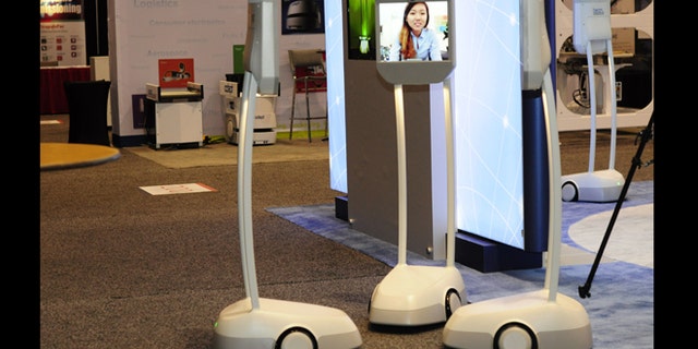 Telepresence robots -- essentially Skype machines that you can wheel around -- attend a conference on robobusiness in California.
