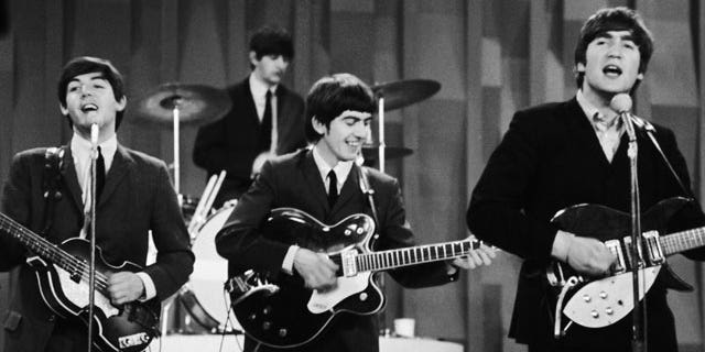 In this Feb. 9, 1964 file photo, The Beatles  perform on the CBS "Ed Sullivan Show" in New York. Ringo Starr plays drums, rear, and playing guitars from left are Paul McCartney, George Harrison and John Lennon.