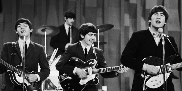 In this Feb. 9, 1964 file photo, The Beatles perform on the CBS "Ed Sullivan Show" in New York. Ringo Starr plays drums, rear, and playing guitars from left are Paul McCartney, George Harrison and John Lennon.