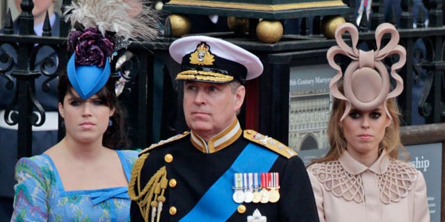 In this Friday, April 29, 2011 file picture Britain's Prince Andrew, center, and his daughters Britain's Princess Eugenie, left, and Britain's Princess Beatrice leave Westminster Abbey at the Royal Wedding in London.