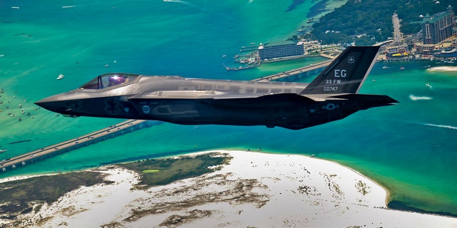 An F-35 Lightning II flies over Destin, Fla., before landing at its new home at Eglin Air Force Base, Fla., July 14, 2011. Its pilot, Lt. Col. Eric Smith is the first Air Force qualified F-35 pilot and is assigned to the 58th Fighter Squadron.