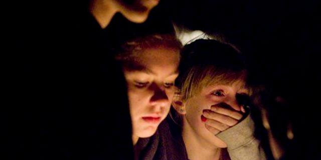 Students become emotional during a vigil for a student who died in an apparent suicide.