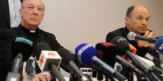 In this April 23, 2010 file photo, Belgium's Archbishop Andre-Joseph Leonard, and commission chairman Peter Adriaenssens address the media in Brussels about the sexually abuse of a Bishop. A Belgian commission looking into sexual abuse by Catholic clergy says it has received testimony from hundreds of victims and that witnesses say widespread abuse over decades led to at least 13 suicides. (AP)