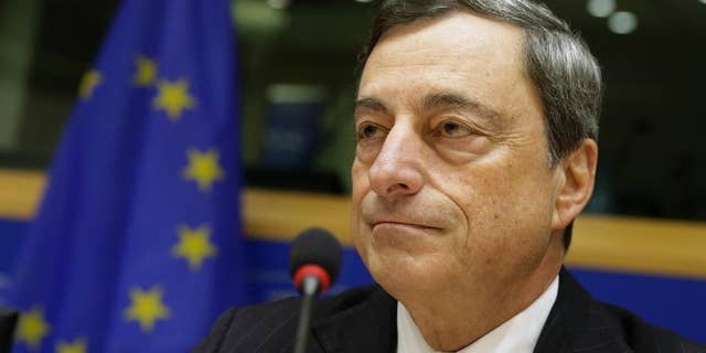 President of the European Central Bank Mario Draghi addresses the Committee on Economic and Monetary Affairs, at the European Parliament building, in Brussels on Monday, Nov. 17, 2014. (AP Photo/Yves Logghe)