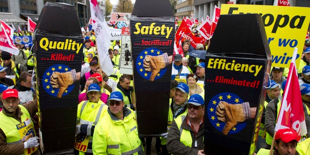 Nov. 5, 2012: Airport ground workers and baggage handlers demonstrate with messages on mock coffins in front of EU headquarters in Brussels.