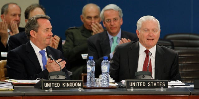 June 8: U.S. Secretary of Defense Robert Gates, right, is applauded by British Defense Secretary Liam Fox during a meeting of the North Atlantic Council at the NATO Defense Ministers Summit in Brussels. NATO's top official said Wednesday the alliance won't put troops on the ground in Libya to keep order once the civil war ends and it will be up to the United Nations to help the north African country toward its future once Qaddafi is no longer at its helm. (AP/Pool)