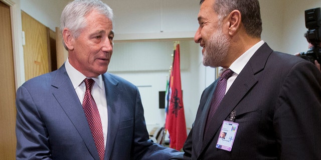 June 4, 2014: U.S. Defense Secretary Chuck Hagel, left, shakes hands with Afghanistan's Defense Minister Bismillah Khan Mohammadi, right, ahead of their North Atlantic Council (NAT) meeting, in Brussels. (AP)