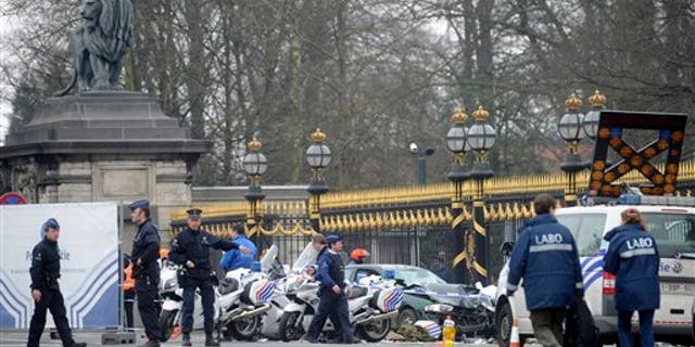 March 13: Police stand at the scene of an accident in front of the Royal Palace in Laeken, Belgium.