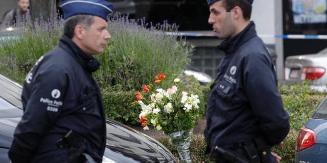 Some flowers were put close to the site of a shooting at the Jewish museum in Brussels, Saturday, May 24, 2014. Three people were killed and one seriously injured in a spree of gunfire at the Jewish Museum in Brussels on Saturday, officials said. The attack, which came on the eve of national and European Parliament elections, led officials to raise anti-terror measures.(AP Photo/Yves Logghe)