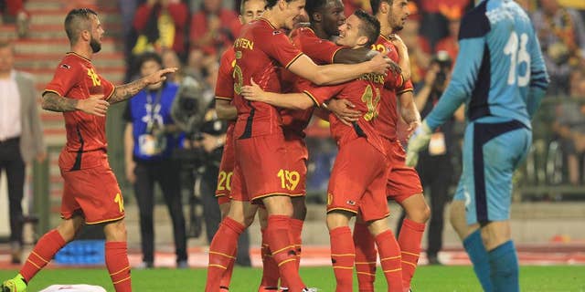 Belgium's Dries Mertens, right, gets congratulations by his team after he scored during a friendly soccer match against Tunisia, at the King Baudouin stadium in Brussels, Saturday, June 7, 2014. Belgium will play against South Korea, Russia and Algeria in Group H of the World Cup 2014 in Brazil. (AP Photo/Yves Logghe)