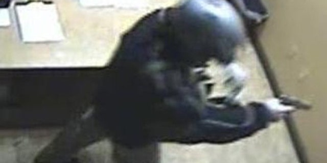 A man with a gun is shown at the scene of a robbery at the Las Vegas Suncoast Casino poker room cashier in this photo taken by surveillance camera on Dec. 9, and released by the Las Vegas Police Department (LVPD) to Reuters. LVPD believe the same man robbed the Bellagio Casino of $1.5 million in chips on Dec. 14 (Reuters).