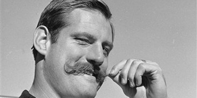 Jan. 3, 1968: In this file photo, Oakland Raiders defensive end Ben Davidson twirls his handlebar moustache in Oakland, Calif., as he contemplated the coming meeting with the Green Bay Packers in the NFL championship game.