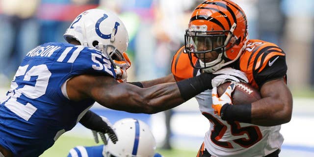 Cincinnati Bengals running back Giovani Bernard (25) is tackled by Indianapolis Colts' D'Qwell Jackson during the first half of an NFL football game Sunday, Oct. 19, 2014, in Indianapolis. (AP Photo/Michael Conroy)