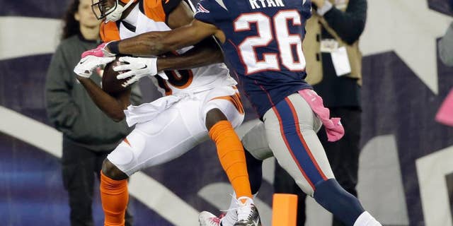 Cincinnati Bengals wide receiver A.J. Green (18) catches a touchdown pass in front of New England Patriots cornerback Logan Ryan (26) in the second half of an NFL football game Sunday, Oct. 5, 2014, in Foxborough, Mass. (AP Photo/Steven Senne)