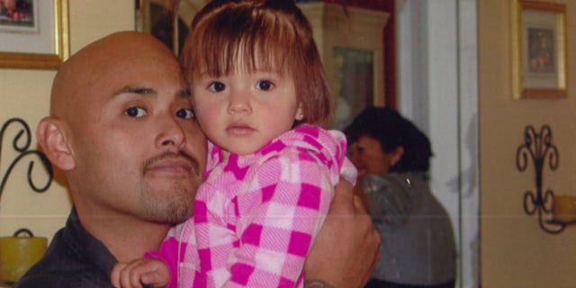 This undated photo provided by Galipo Law shows Benny Herrera holding his daughter, Abygail. A federal appeals court says a dashboard video shows a California police officer shooting and killing a man less than a second after ordering him to show his hands. The court noted the video footage Friday, Sept. 16, 2016, in rejecting Tustin Police Officer Osvaldo Villareal's request to dismiss the wrongful death lawsuit against him. The 9th U.S. Circuit Court of Appeals in San Francisco said Villareal couldn't have reasonably feared for his safety when he shot Herrera in December, 2011. (Galipo Law via AP)