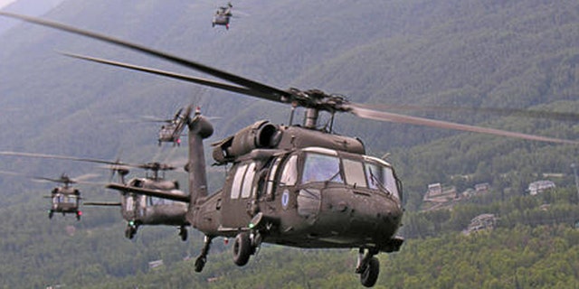 Six Alaska Army National Guard UH-60L Black Hawk helicopters bank over Eagle River Monday morning on the way to landing at Elmendorf Air Force for loading aboard heavy airlifters for transport to Iraq. A total of ten Army Guard Black Hawks from the 1-207th Aviation Battalion at Bryant Air Air Field on Ft. Richardson made the short hop Monday morning. The helicopters will be shipped to Iraq and the approximately 100 pilots and crewmembers will head out in August to rejoin their aircraft for a year-long deployment.