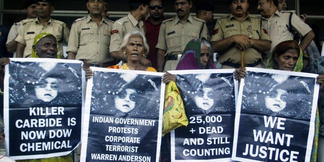 June 7: Victims of Bhopal gas tragedy hold posters during a demonstration outside a court in the central Indian city of Bhopal. An Indian court on Monday sentenced seven people to two years each in prison for negligence in failing to prevent one of the world's worst industrial accidents that killed thousands of people in 1984.