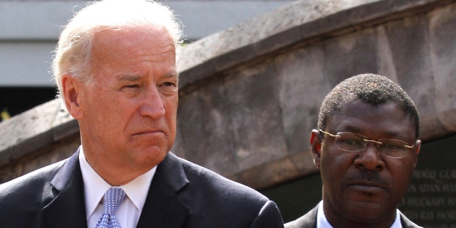 Vice President Biden and Kenyan Foreign Affairs Minister Wetangula look on after laying a wreath at the site of the former U.S. Embassy in Nairobi. While in Kenya, Biden expressed support for the proposed new constitution, which Kenya approved on Aug. 4. (Reuters)