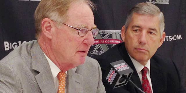 Oklahoma State President and Chairman of the Big 12 board of directors Burns Hargis, , left, and Big 12 Commissioner Bob Bowlsby, talk at the end of the Big 12 meetings at the Four Seasons Resort and Hotel in Irving, Texas, on Friday, May 30, 2014. (AP Photo/Stephen Hawkins)