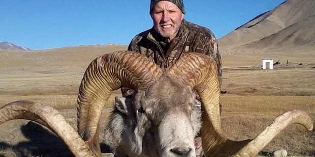 This Dec. 2012 photo provided by Rick Vukasin shows Vukasin, 65, of Great Falls, Mont., posing with a rare argali sheep known as the "Marco Polo'' that he shot in the Pamir mountains of northeast Tajikistan near Karakul Lake along the Chinese border. Vukasin filed a lawsuit in U.S. District Court in Reno on Feb. 6, 2014 against a Tajikistani guide and Canadian outfitter he accuses of defrauding him by shipping him horns taken from an animal other than the 58-inch long ones he says belonged to the sheep he shot. (AP Photo/Rick Vukasin)