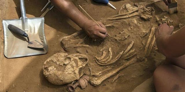 This Tuesday, June 28, 2016 photo shows archeologists excavating an ancient Philistine cemetery near Ashkelon, Israel.
