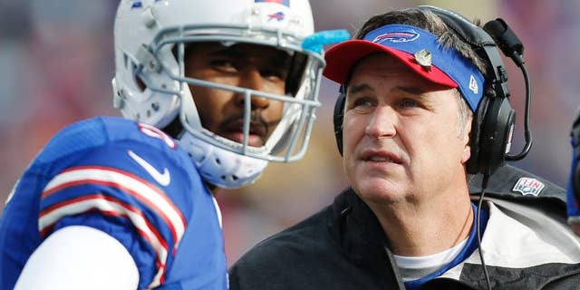 FILE - In this Nov. 17, 2013 file photo, Buffalo Bills head coach Doug Marrone, right, and Buffalo Bills quarterback EJ Manuel talk during the first half of an NFL football game against the New York Jets, in Orchard Park, N.Y. Leaving the Bills defense to new coordinator Jim Schwartz, Marrone is making the retooled EJ Manuel-led offense his primary focus during the team's spring minicamp sessions.(AP Photo/Gary Wiepert, File)