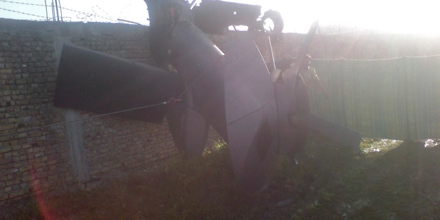 May 2, 2011: Part of a damaged helicopter is seen lying near the compound after U.S. Navy SEAL commandos killed Al Qaeda leader Usama bin Laden in Abbottabad, Pakistan