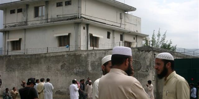In this May 5, 2011 file photo, local residents and media are seen outside the house where Al Qaeda leader Usama bin Laden was caught and killed in Abbottabad, Pakistan. The courier who led U.S. intelligence to bin Laden's hideout in Pakistan hailed from the Swat Valley, a one-time stronghold of militant Taliban fighters, Pakistani officials said. (AP/File)