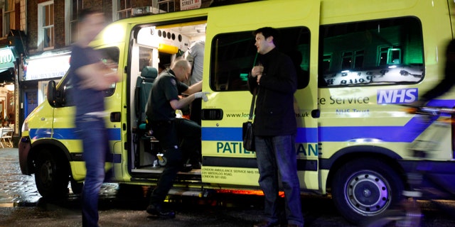 April 21: A man is taken into the ambulance, known as a 'booze bus,' dedicated to keeping drunk people out of trouble on the streets, and out of hospital emergency rooms in the Soho area of central London.