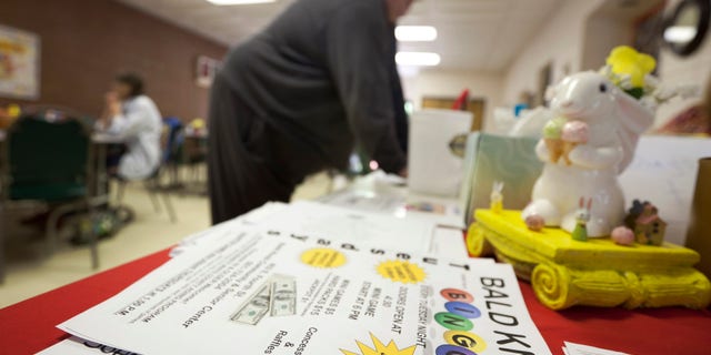 April 10: John Lancaster from Floyd, Ark., buys Bingo cards before a game in Bald Knob, Ark.