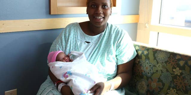 Brittany Young, 24, of Des Moines, Iowa, went into labor and had delivered her baby, Miracle, in the shower of her apartment. Young knew she was pregnant, but thought she was earlier along than she was on Wednesday, March 11, 2015, Des Moines, Iowa. (AP Photo/The Des Moines Register, Bryon Houlgrave)
