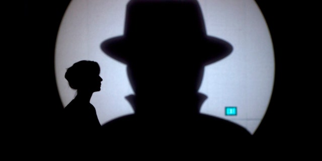 Speaker liaison Genevieve Netter is silhouetted against a Black Hat logo during the Black Hat USA 2014 hacker conference at the Mandalay Bay Convention Center in Las Vegas, Nevada August 6, 2014. REUTERS/Steve Marcus (UNITED STATES - Tags: SCIENCE TECHNOLOGY TPX IMAGES OF THE DAY) - RTR41H1N