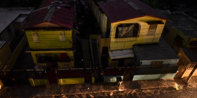 Vehicle lights illuminate a street after a massive blackout, in San Juan, Puerto Rico, Thursday, Sept. 22, 2016. Puerto Ricans faced another night of darkness Thursday as crews slowly restored electricity a day after a fire at a power plant caused the aging utility grid to fail and blacked out the entire island. (AP Photo/Carlos Giusti)