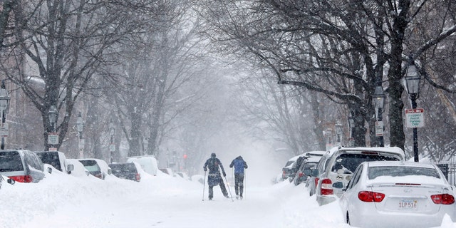 Two people cross-country ski up Marlborough Street during a blizzard in Boston, Massachusetts Jan. 27, 2015.
