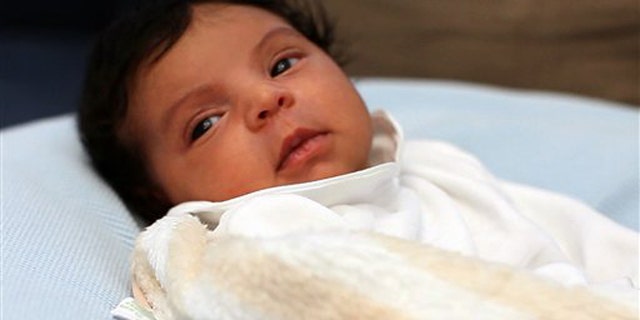 In this undated image released by Beyonce.com, Blue Ivy, the daughter of performers Beyonce Knowles and Jay-Z, is shown in a recent family photo.