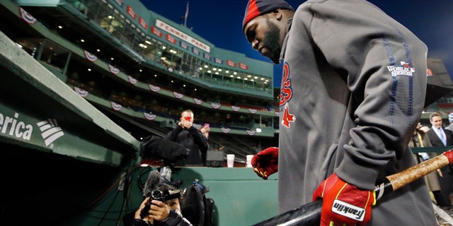 Boston Red Sox designated hitter David Ortiz walks into the dugout after a workout at Fenway Park in Boston, Tuesday, Oct. 29, 2013. The Red Sox are scheduled to host the St. Louis Cardinals in Game 6 of baseball's World Series on Wednesday. (AP Photo/Elise Amendola)