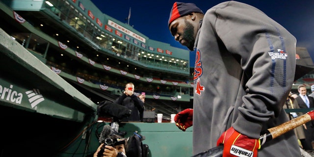 Boston Red Sox designated hitter David Ortiz walks into the dugout after a workout at Fenway Park in Boston, Tuesday, Oct. 29, 2013. The Red Sox are scheduled to host the St. Louis Cardinals in Game 6 of baseball's World Series on Wednesday. (AP Photo/Elise Amendola)