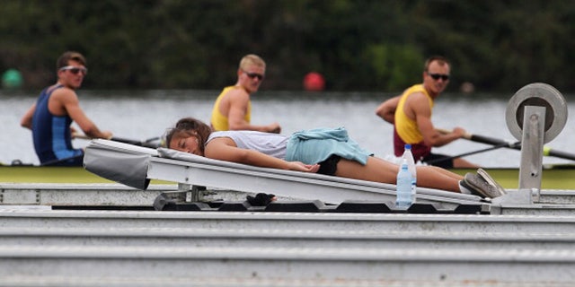 CAMBRIDGE, NEW ZEALAND - FEBRUARY 18: A boat holder takes a nap during the Bankstream New Zealand Rowing Championships at Lake Karapiro on February 18, 2014 in Cambridge, New Zealand. (Photo by Joel Ford/Getty Images)