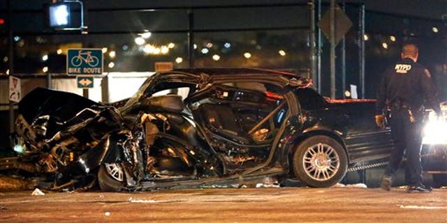 A police officer surveys the scene following an accident in New York, Wednesday, Feb. 11, 2015, that killed longtime "60 Minutes" correspondent Bob Simon. Simon covered riots, Academy Award-nominated movies and wars and was held captive for more than a month in Iraq two decades ago. He was 73. (AP Photo/Kathy Willens)